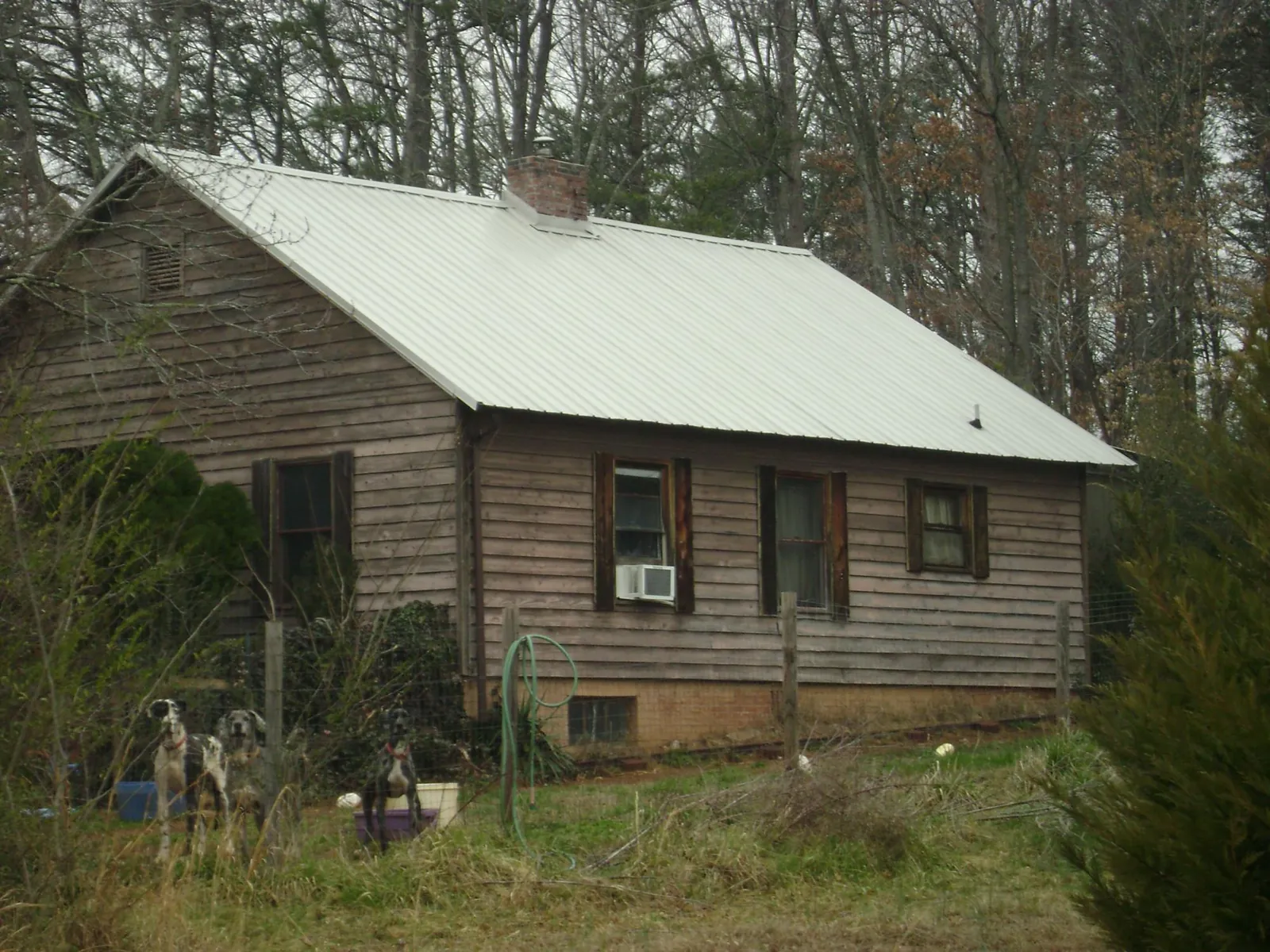 White metal roof on an old wood sided farmhouse, from a Metal Roof Installation job in Seabrook
